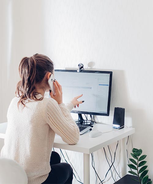 A person in athletic clothing sits on the gym floor after a workout, with a yellow kettlebell and a black water bottle in the foreground. The scene is set in a fitness studio with gym equipment in the background, capturing a moment of rest or recovery.